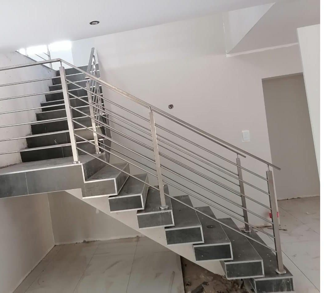 Stainless steel horizontal rod balustrade on a tiled interior staircase
